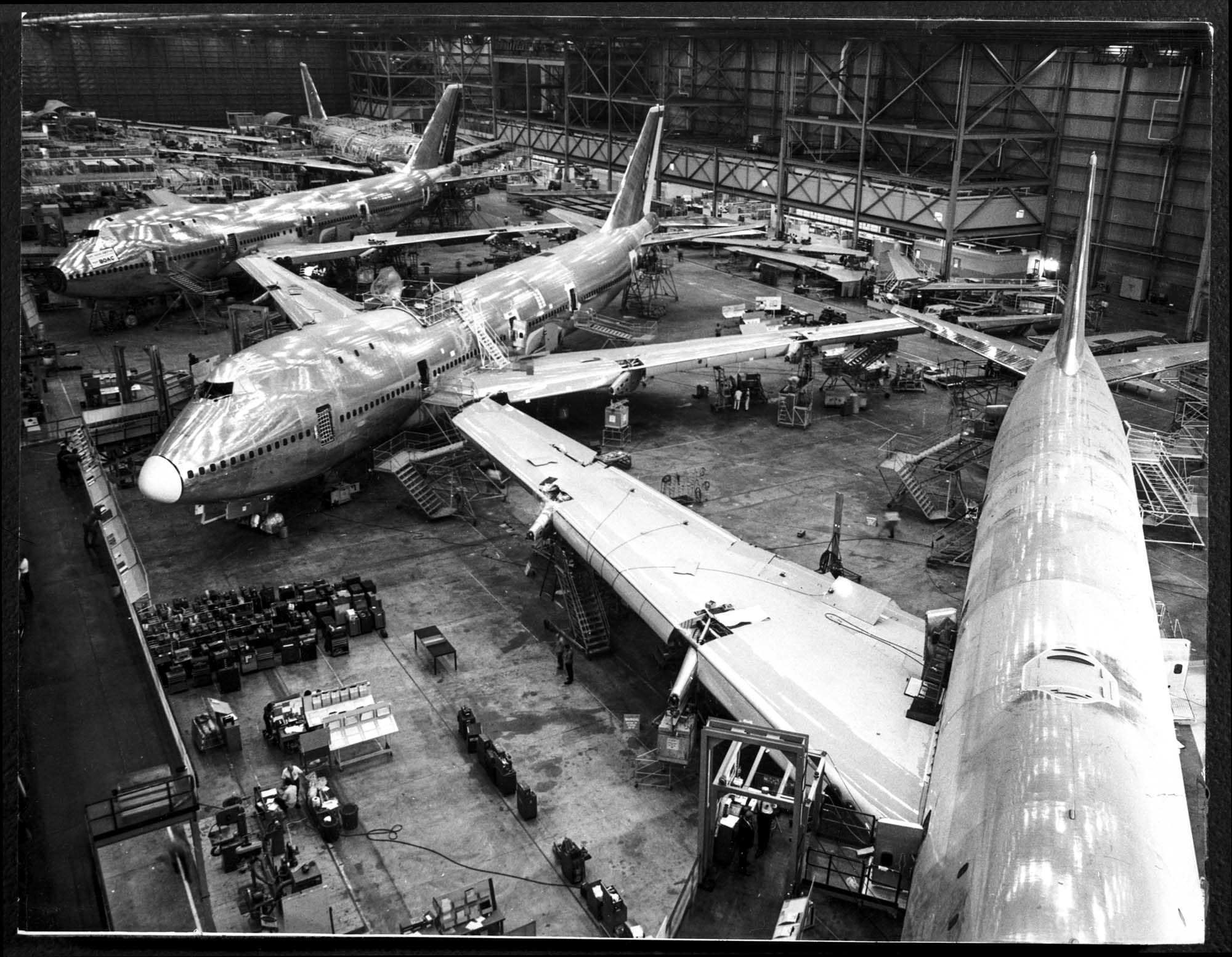 Three 747s partially built in a hanger.