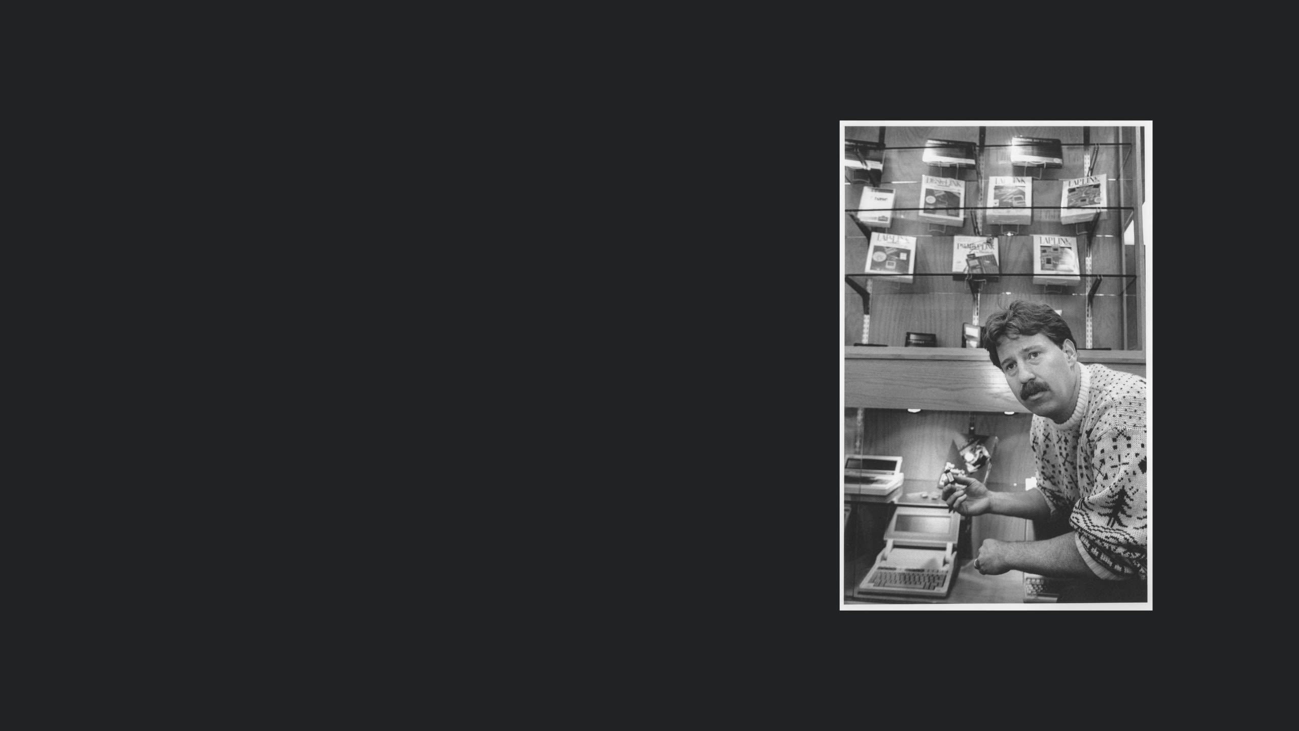 A person in front of a display of software.