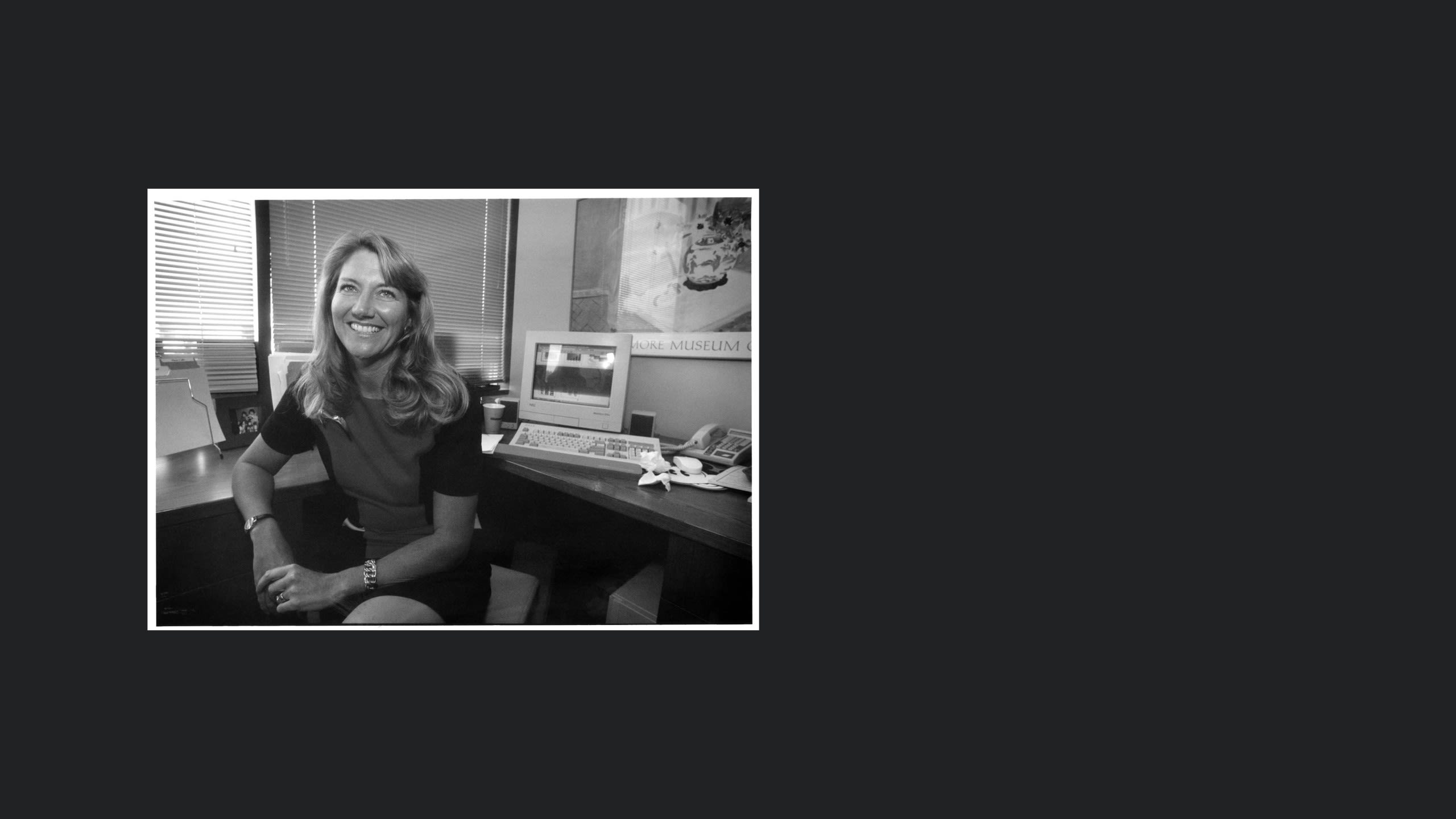 Portrait of woman at computer desk.