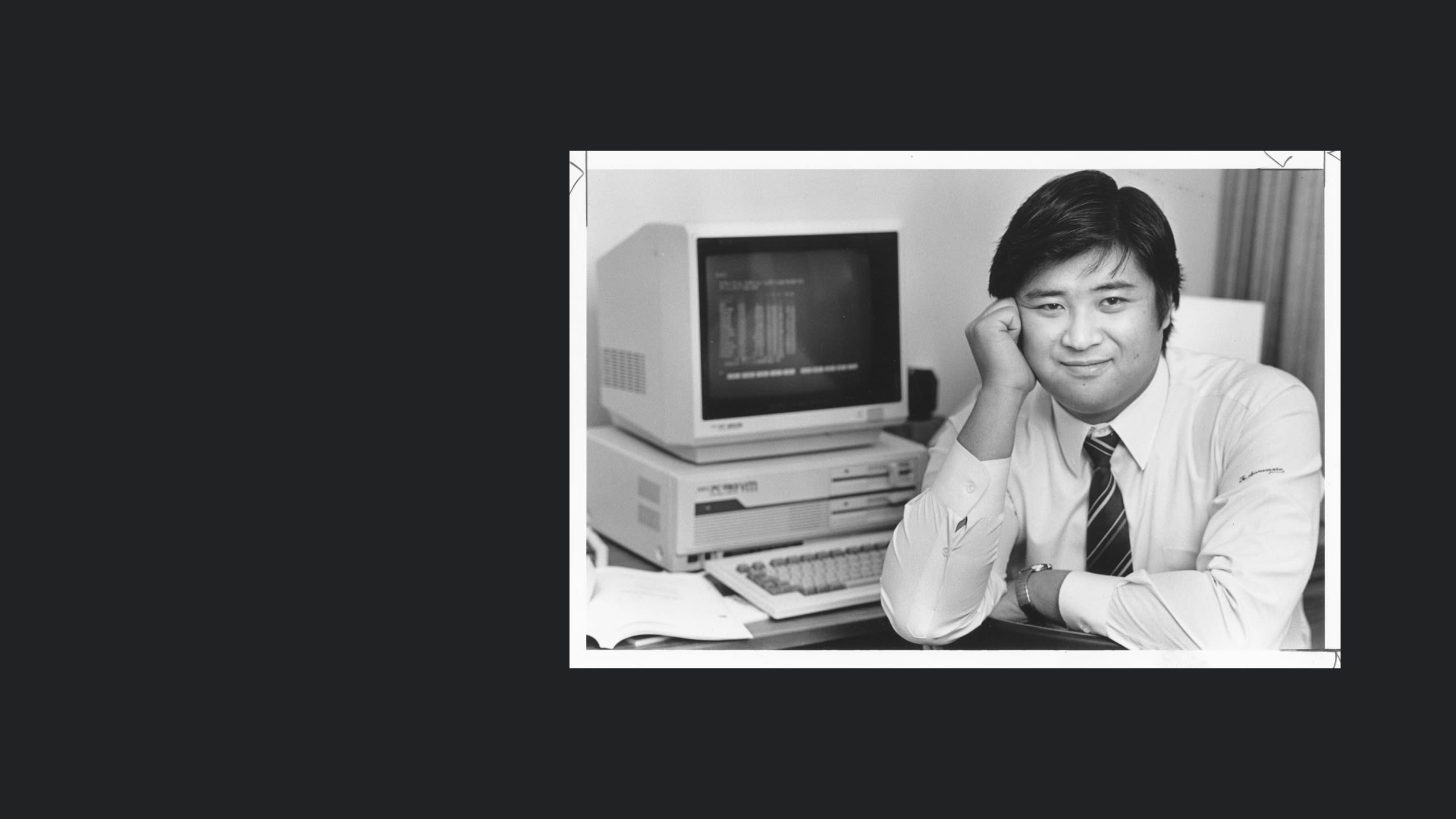 A person at a desk with computer.